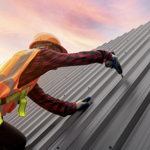 single man painting the roof of a house